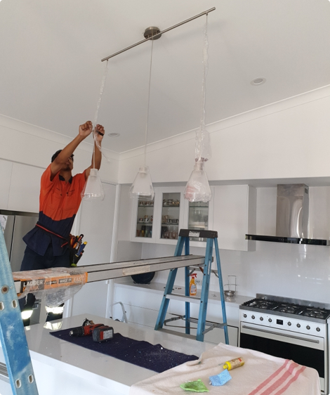 Our Team Fixing a LIght — Sunny's Electrical In Townsville, QLD