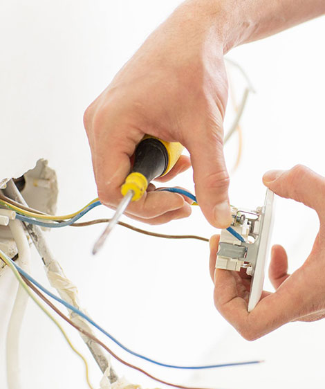 Electrician Wiring a Wall Socket — Sunny's Electrical In Townsville, QLD